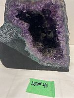 Front view of geode showing full cut face with purple crystals