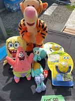 All plush toys and nightlights shown together to display full lot contents on outdoor table