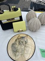 Photo showing the vintage bubble glass framed Persian cat pencil drawing, the three decorative pumpkin-shaped pieces, and the lime green wallet and matching clutch on a white tabletop.