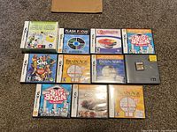 Photo of 11 Nintendo DS games displayed on a surface showing cases, instruction manuals, and loose cartridge.