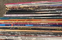 Photo of vinyl record spines showing titles and artists including The Police, Michael Jackson, Duran Duran, Supertramp, Culture Club, Eddie Murphy, Phil Collins, David Bowie, Styx.