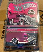 Photo of front card packaging with pink Hot Wheels Blown Delivery truck in blister pack showing the artwork and the toy.