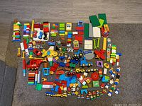 Photo showing full spread of all items including vehicles, mini figures, animals, and building blocks.