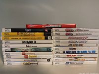 Front view of stacked Nintendo Wii game cases showing titles and condition.