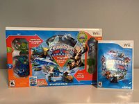 Front boxed view of Skylanders Trap Team Starter Pack for Nintendo Wii including two Skylanders figures visible, original packaging, and game disc case.