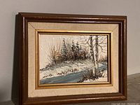 Full view of the framed small oil painting of winter landscape.