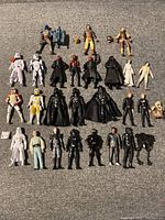 Photo showing 25 Star Wars 3.75-inch action figures arranged on fabric surface