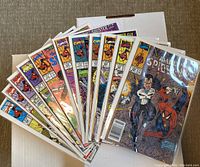 11 issues of Amazing Spider-Man comics fanned out in plastic protective bags.
