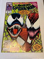Front cover showing Venom and Carnage with green background and spider web motifs