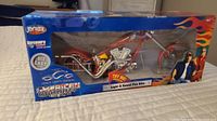 Front view of the unopened Orange County Choppers American Chopper Light & Sound Fire Bike die cast motorcycle in original packaging with flame detail and try me button.