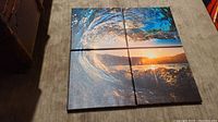 Set of 4 ocean wave themed canvas prints arranged on floor forming a single cohesive image of a wave at sunset.