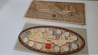 Photo showing the full Millennium Canada 1999 quarter coin collection and the packaging with the replica map.