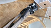 Close-up photo of the Optex OPT455 tripod showing the branded aluminum leg and part of the pan head.