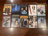 10 DVDs laid out on a wooden floor showing front cover art for each movie.