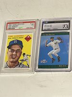 Both graded baseball cards displayed side-by-side showing front art and grading labels.