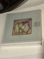 Top view of closed original box showing the design decal of wine glasses and grapes on the frosted glass bowl inside