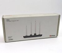 Box with front image showing four candles in the Iittala Allas candle holder.