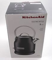 Box front showing KitchenAid Electric Kettle with 5 cups capacity and stylish compact design. Black kettle with silver handle and spout shown.