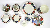 Overview of entire lot showing plates, bowls, cups with saucers, shakers, sugar bowl with lid, bread and salad plates arranged on white background