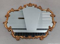 Full view of the large vintage wall mirror showing its ornate gold frame with Baroque Victorian style curled and floral motifs.