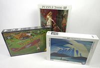 Front view of all three puzzles showing artwork and box designs.