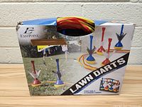 Photo of Eastpoint lawn darts set box showing product image of six darts and a target ring for outdoor lawn play.