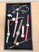 Tray of eleven wristwatches with various bands and faces