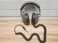 Front view of vintage Koss K6 headphones showing their general shape, ear cups, and coiled cable with 1/4-inch plug.