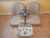 Two tan vinyl car seats, wood rim steering wheel, Stewart Warner gauge package boxed