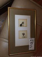 Framed view of both small ink drawings matted and signed, showing full gold-tone frame and beige mat.