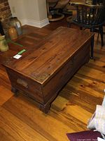 Front and top perspective of wooden chest on hardwood floor