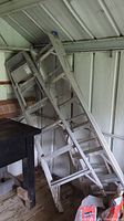 Photo showing the 12 ft combination ladder leaned against shed wall with visible rungs and extension section.