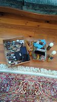 Overview of lot showing two boxes: one with multiple wrist watches, wallets, and shoe care brushes; the other with shoe polish tins, brushes, and cleaning cloths. Sprays are placed adjacent.