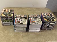 Stacked group of 20 UniKeep disc wallets in original box packaging showing front and side views.