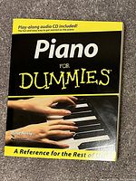 Front cover of 'Piano For Dummies' book showing title, author Blake Neely, and mention of included play-along audio CD.