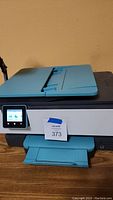 Photo of HP OfficeJet Pro 8020 Series printer showing front with paper tray and touchscreen display.