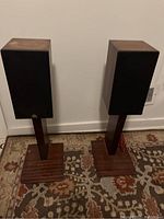 Pair of Castle speakers on wooden stands showing overall size and appearance.