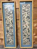 Both framed panels side by side against a wood backdrop