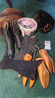 Full view of all items in the lot including boots, shoe stretchers, muffs, gloves, spats, and a floral box.