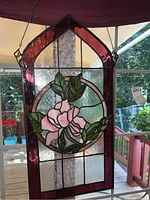 Front view of the stained glass panel showing floral design and red border.