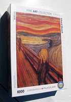 Front of the unopened puzzle box showing Edvard Munch's The Scream painting with 'Fine Art Collection' and '1000 pieces' indicated.
