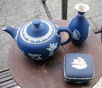 Photo of the Wedgwood teapot, vase and box set together on a wooden surface
