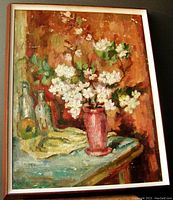 Full view of framed oil painting showing blossoms, vase, bottles and table