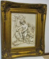 Overall view of gilt wood gothic style frame with raised relief sculpture of cherub and lion