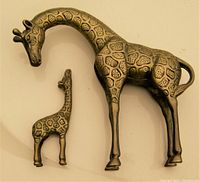 Top view of the solid brass giraffe pair, showing detailed textured giraffe patterns and relative size of mother and baby figures.