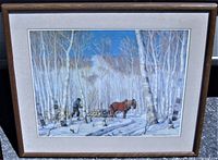 Framed signed art print showing a winter scene with horse, sleigh, man, and birch trees.