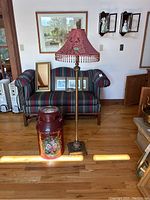 Milk can and floor lamp side by side showing size, positioning, and style