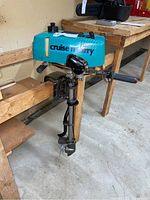Full view of Cruise 'n Carry outboard motor mounted on bench