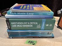 Stack of six medical books related to anesthesiology and nerve blocks shown clearly from spine and side view.