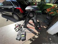 Full view of Bowflex Upper Cut arm trainer with attached resistance bands, Pro Line workout gloves and Grizzly head harness on table.